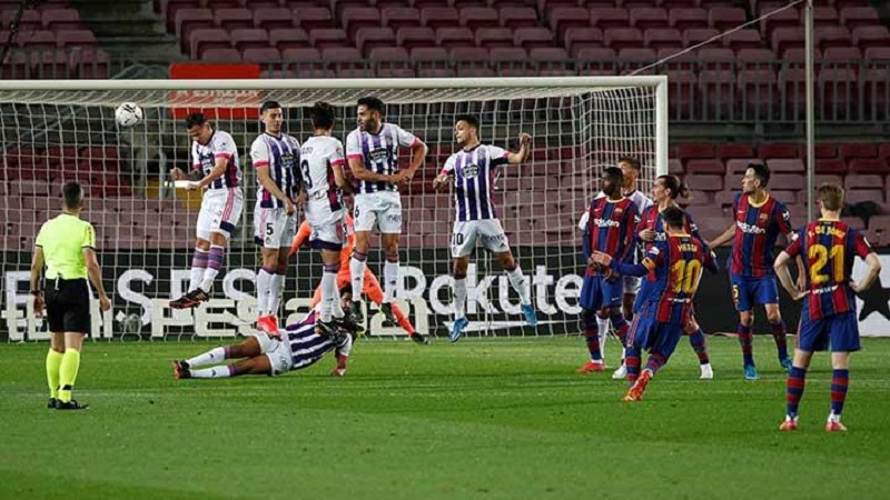 Penyerang Barcelona Lionel Messi, melakukan tendangan bebas ke gawang Real Valladolid dalam pertandigan Liga Spanyol di Camp Nou, Barcelona, 6 April 2021. REUTERS/Albert Gea
