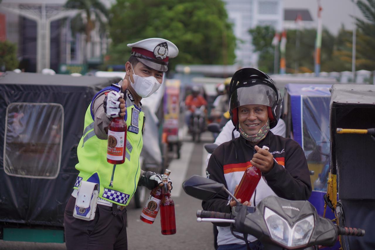 Dirlantas Polda Aceh berbagi sirup kepada abang becak di Banda Aceh. (Foto: Dok.Ist)