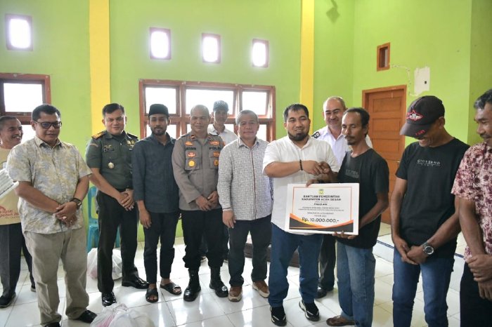Pj Bupati Aceh Besar Muhammad Iswanto menyerahkan bantuan kepada korban musibah Angin Kencang dan kebakaran rumah, yang berlangsung di Aula Kantor Camat Seulimum, Aceh Besar, Rabu (28/06/2023). (Foto: Ist)