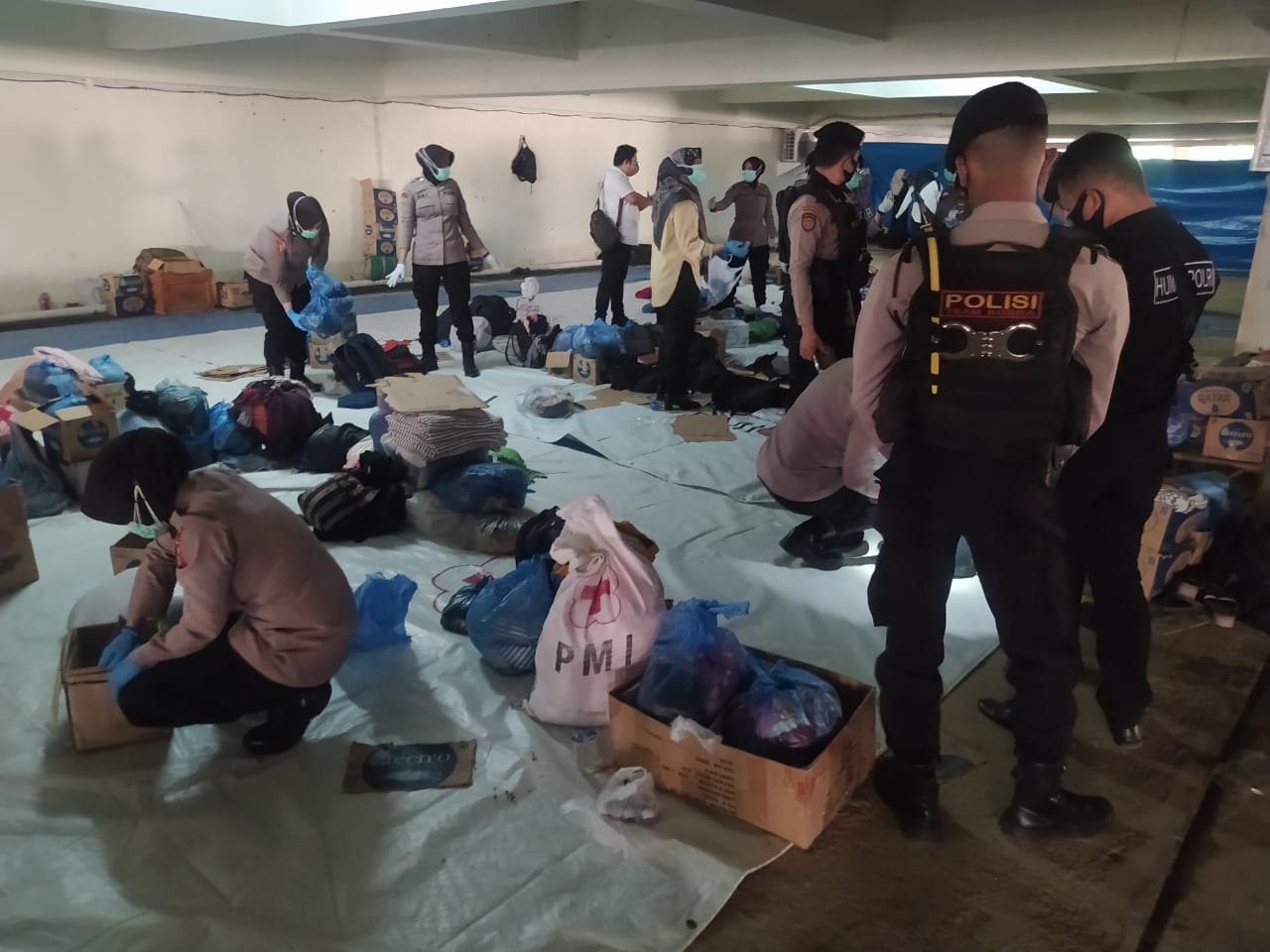 Personel Polresta Banda Aceh dan Polda Aceh saat menggeledah barang bawaan pengungsi rohingya di Balai Meuseuraya Aceh (BMA), Kota Banda Aceh. (Foto: Dok. Humas Polda Aceh)