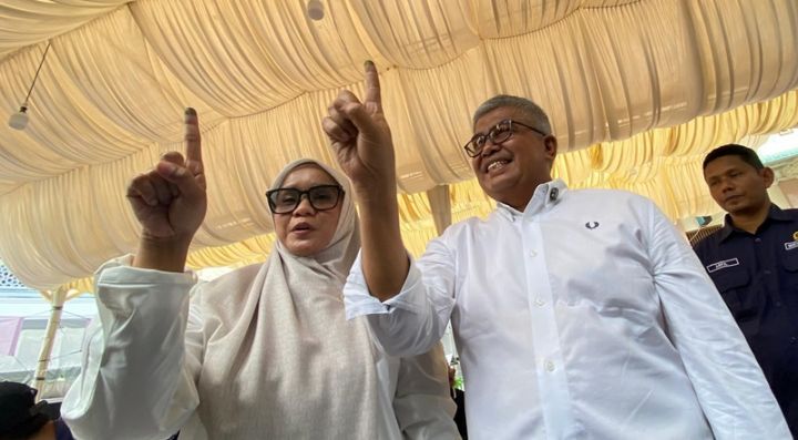 Bustami Hamzah dan istrinya Mellani Subarni menggunakan hak pilihnya pada Pilkada Aceh 2024 di TPS Kampung Pineung, Kecamatan Syiah Kuala, Kota Banda Aceh. (Foto: Metrotvnews.com)