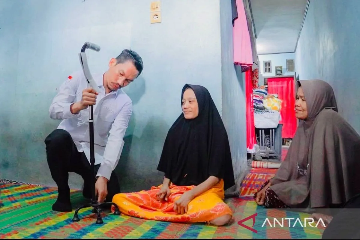 Bupati Aceh Barat Tarmizi memberikan bantuan tongkat kepada seorang warganya yang sakit di Kecamatan Meurebo, Kabupaten Aceh Barat, Minggu (20/4/2025). (Foto: ANTARA)
